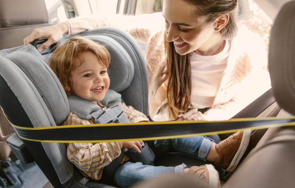 A joyful toddler in the UPPAbaby Knox convertible car seat in Jordan fashion, featuring a rear-facing setup for enhanced child safety on the road.